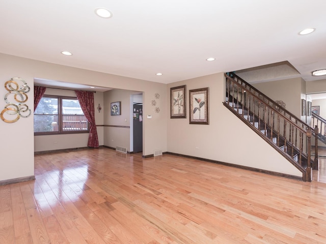 unfurnished living room with light wood-type flooring