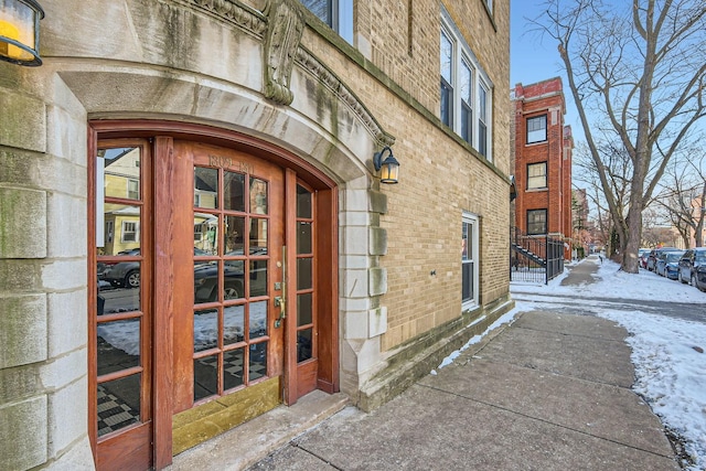 view of snow covered property entrance