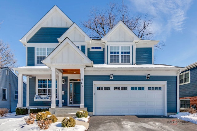 view of front of property with board and batten siding, driveway, and a garage