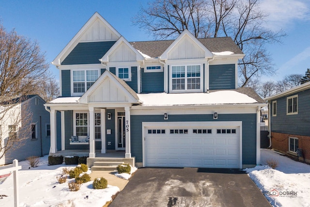 view of front of property with board and batten siding, driveway, a shingled roof, and a garage