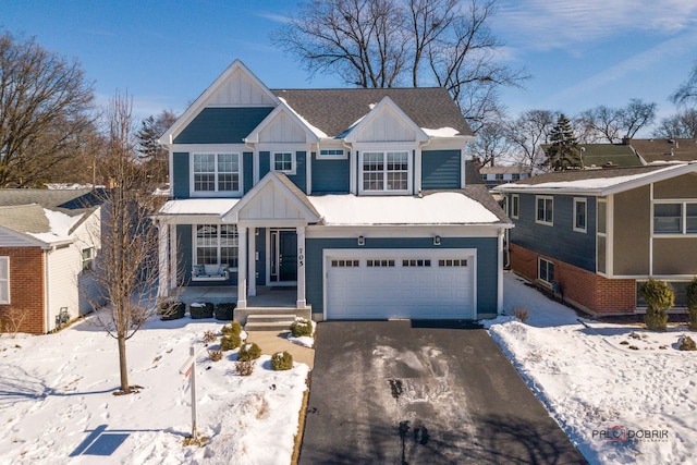 view of front of home featuring board and batten siding, a residential view, driveway, and a garage