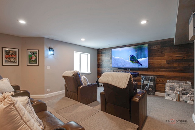 carpeted home theater with baseboards, wood walls, and recessed lighting