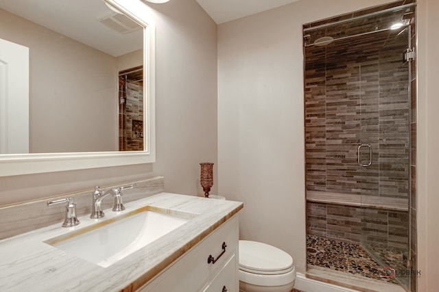 bathroom with toilet, a stall shower, visible vents, and vanity