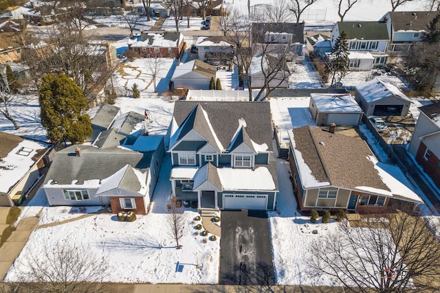 snowy aerial view with a residential view