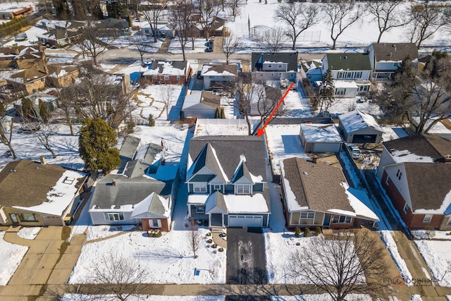 snowy aerial view with a residential view