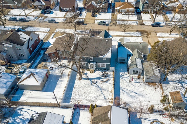 snowy aerial view with a residential view