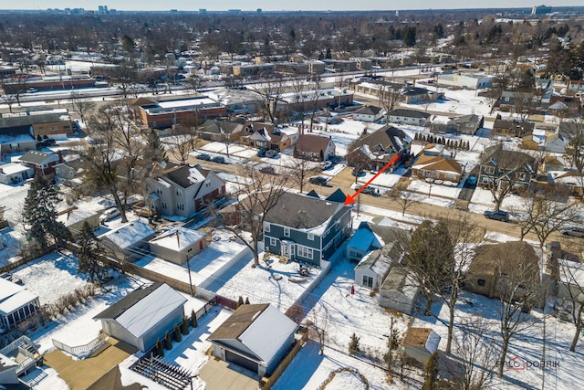 snowy aerial view with a residential view