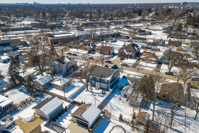 snowy aerial view featuring a residential view