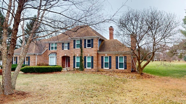 7N108 Hastings Dr, Saint Charles, IL 60175 - colonial-style house with brick siding, a front yard, and a chimney