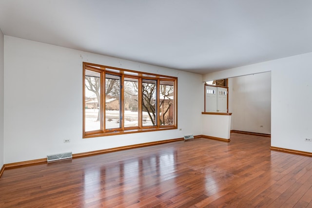 spare room with wood-type flooring