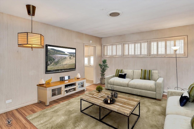 living room with wood finished floors and baseboards