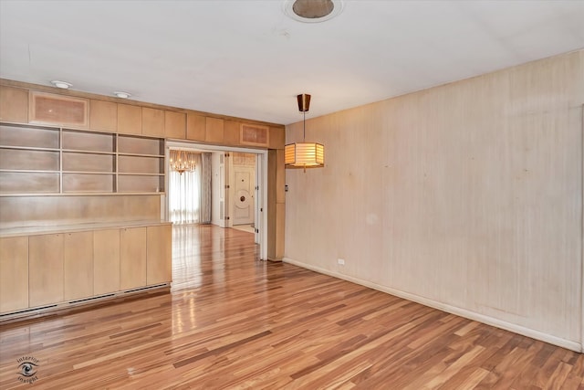 unfurnished room featuring light wood-style floors and baseboards