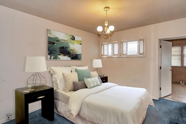 carpeted bedroom with a chandelier