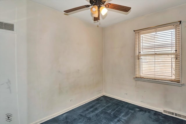 spare room with ceiling fan, baseboards, visible vents, and dark carpet