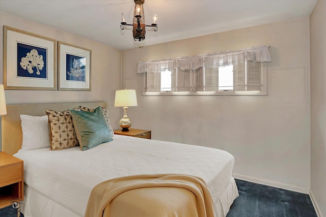 bedroom with baseboards and an inviting chandelier