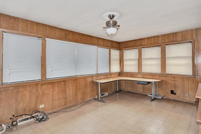 unfurnished sunroom with a ceiling fan