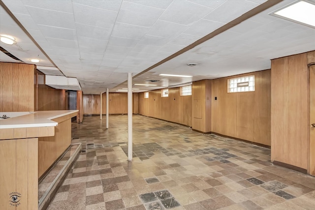 basement with wooden walls and baseboards