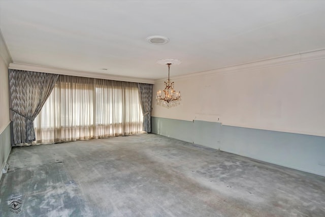 unfurnished room with ornamental molding and an inviting chandelier