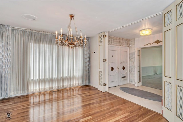 interior space featuring an inviting chandelier and wood finished floors