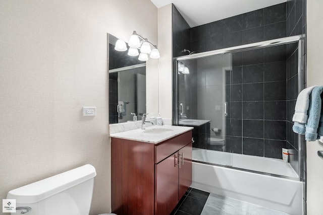 full bathroom with enclosed tub / shower combo, vanity, toilet, and tile patterned floors