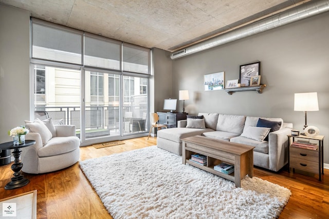 living room with expansive windows and hardwood / wood-style flooring