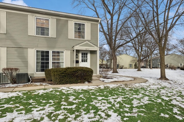 view of front of home with entry steps and central AC