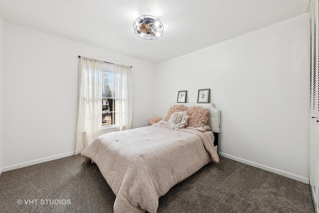 bedroom with baseboards and dark colored carpet