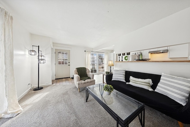 living room featuring light carpet and baseboards