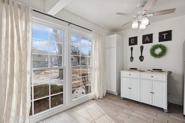 interior space featuring a ceiling fan, wood tiled floor, and baseboards