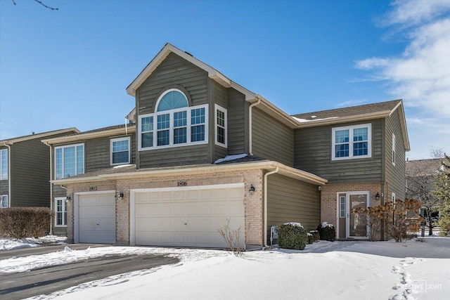 view of front of home with brick siding and an attached garage