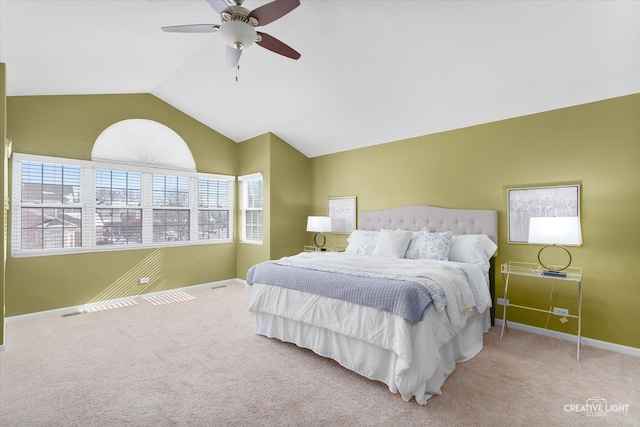 bedroom with vaulted ceiling, ceiling fan, light carpet, and baseboards