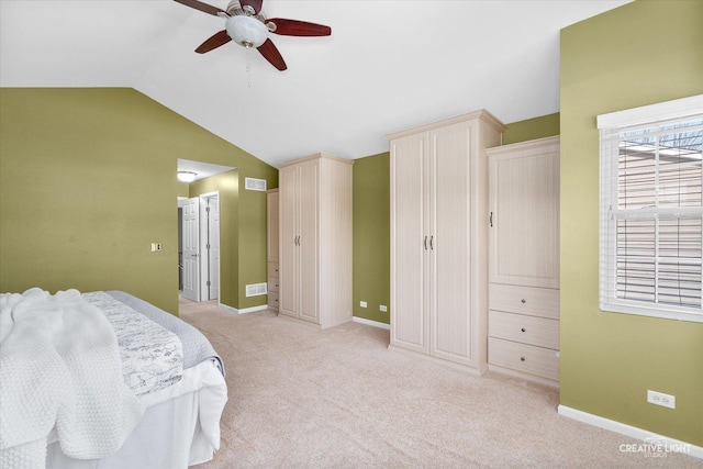 bedroom featuring lofted ceiling, light carpet, visible vents, and baseboards