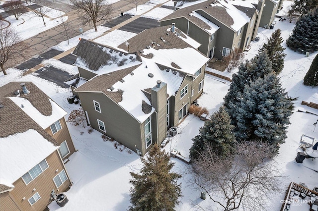 snowy aerial view featuring a residential view