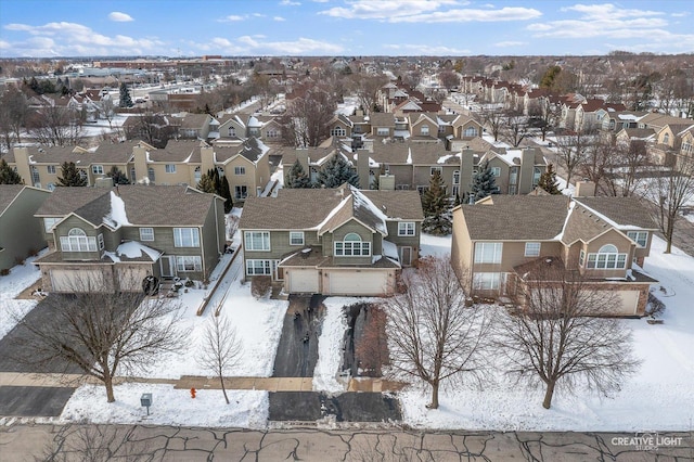 snowy aerial view featuring a residential view