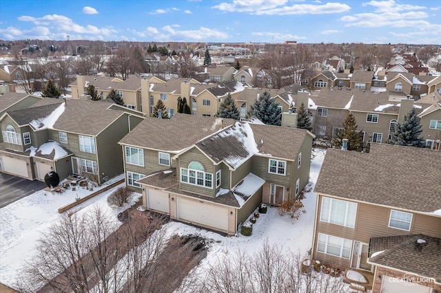 snowy aerial view featuring a residential view