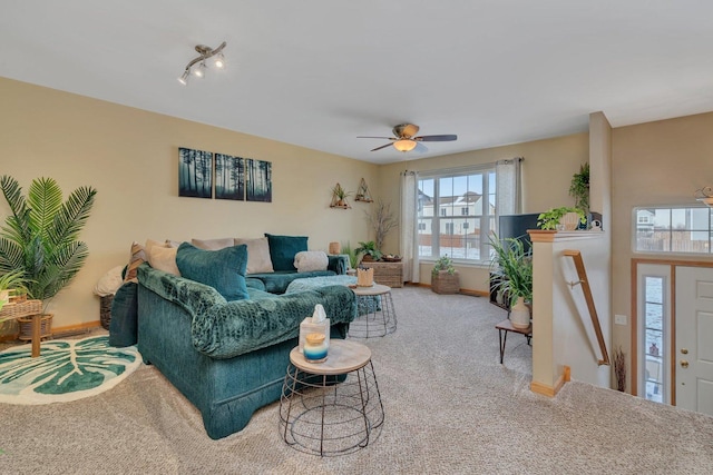 living room featuring carpet and ceiling fan