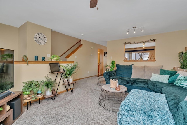 carpeted living room featuring rail lighting