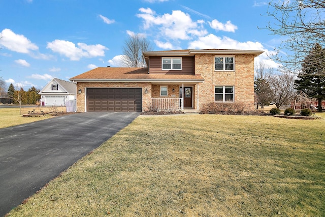 traditional home featuring aphalt driveway, an attached garage, a shingled roof, brick siding, and a front yard