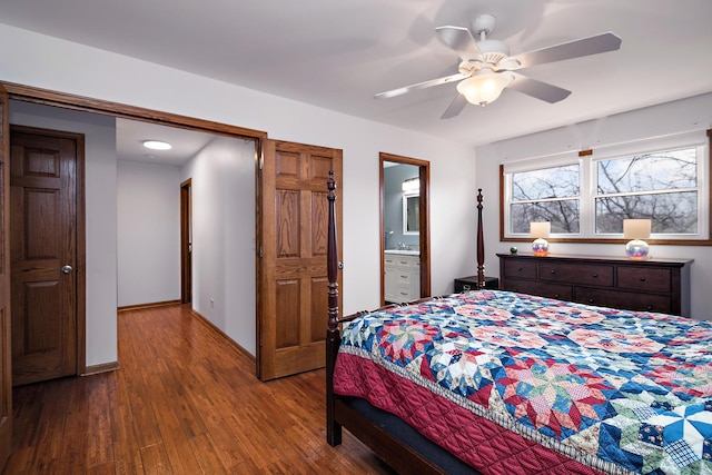 bedroom with a ceiling fan, connected bathroom, baseboards, and wood finished floors