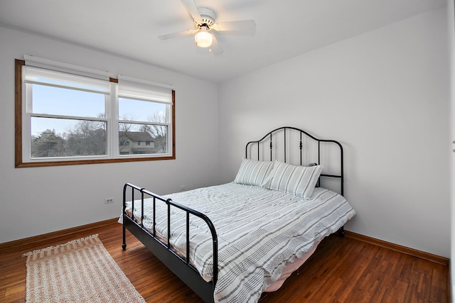 bedroom with wood finished floors, a ceiling fan, and baseboards