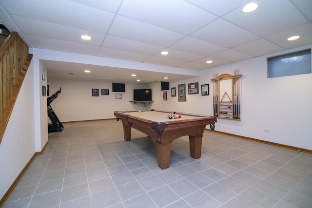 recreation room with light tile patterned floors, a drop ceiling, and baseboards