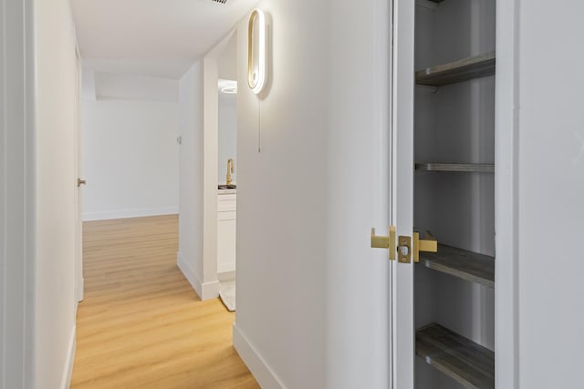 hall with light hardwood / wood-style floors