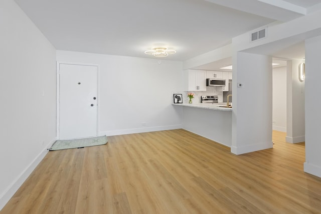 unfurnished living room with light wood-type flooring