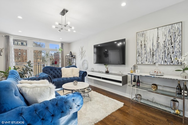 living room featuring dark hardwood / wood-style floors and a notable chandelier