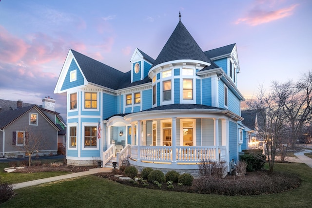 view of front of house featuring a yard and covered porch