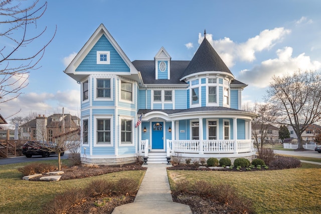 victorian home featuring covered porch and a front lawn