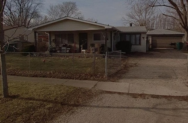 single story home featuring a fenced front yard and a detached garage