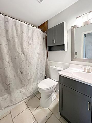 full bath with a shower with shower curtain, vanity, toilet, and tile patterned floors