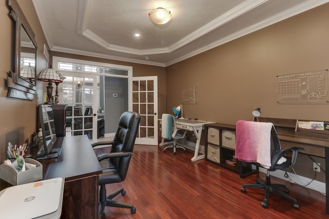 office space with ornamental molding, a tray ceiling, and wood finished floors