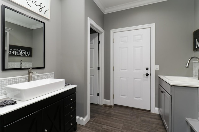 bathroom featuring two vanities, a sink, and crown molding